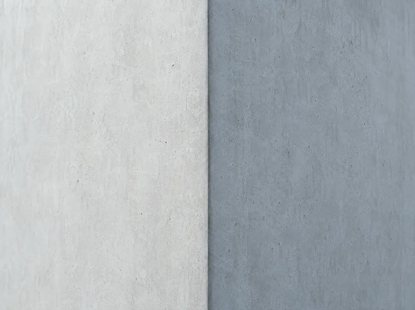 An extreme close view of two concrete planes meeting at an exact right angle.