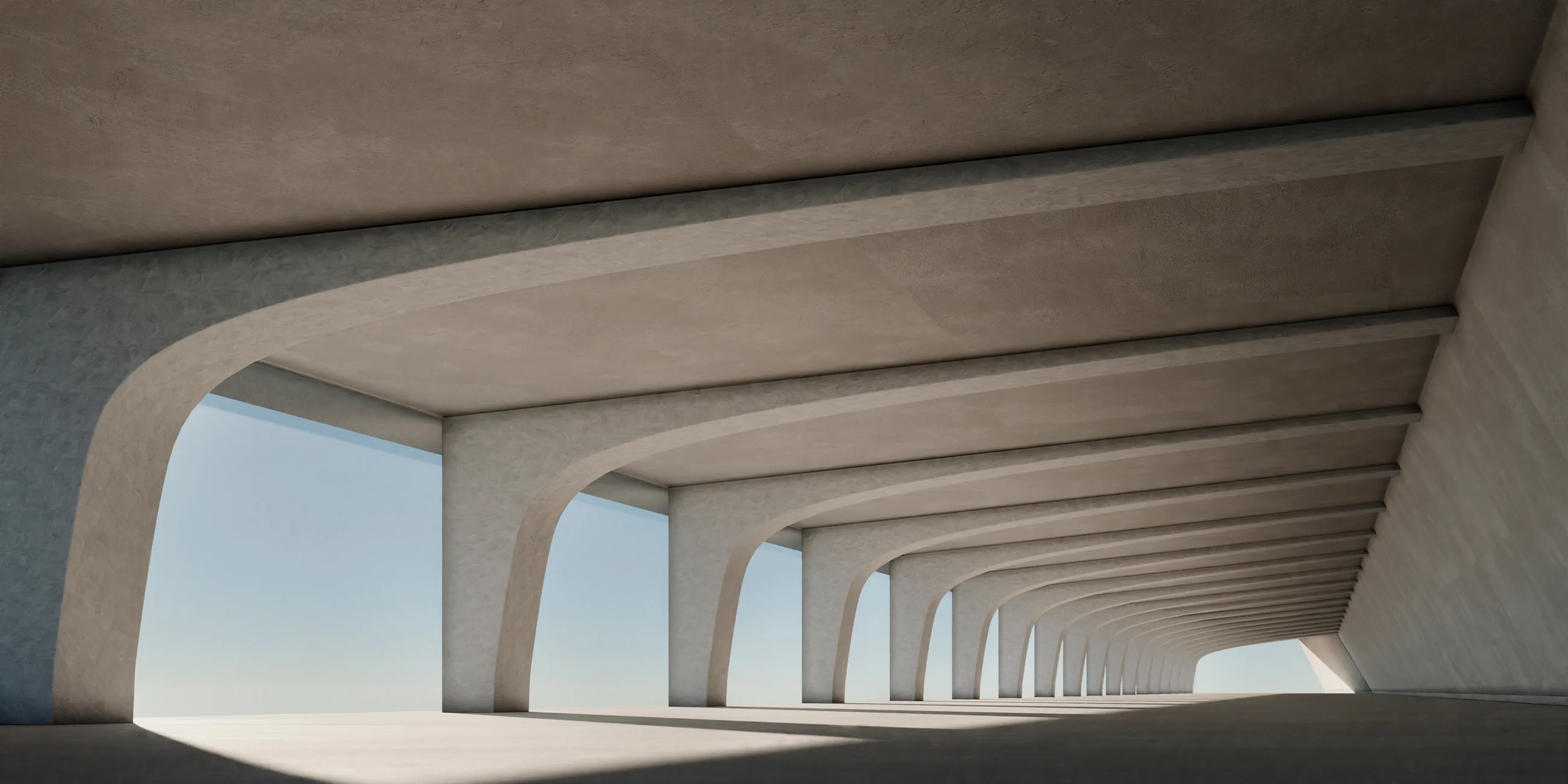 A long curved concrete arcade, its arches receding toward a pale horizon.