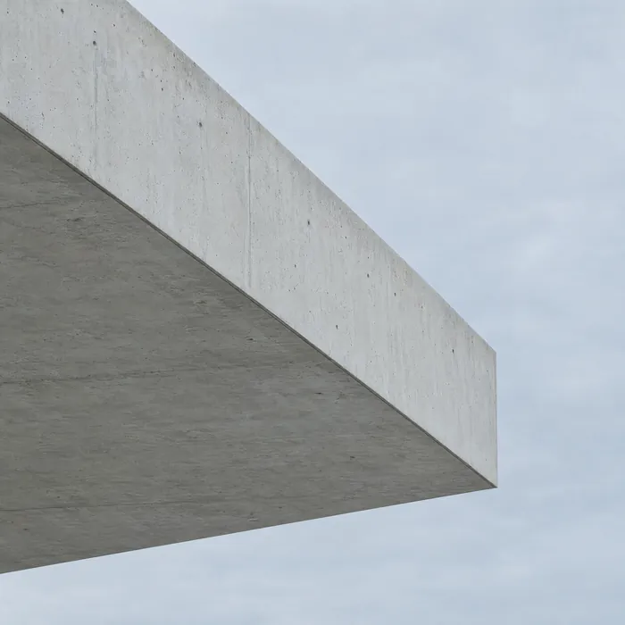The exposed edge of a concrete floor slab against a pale sky.